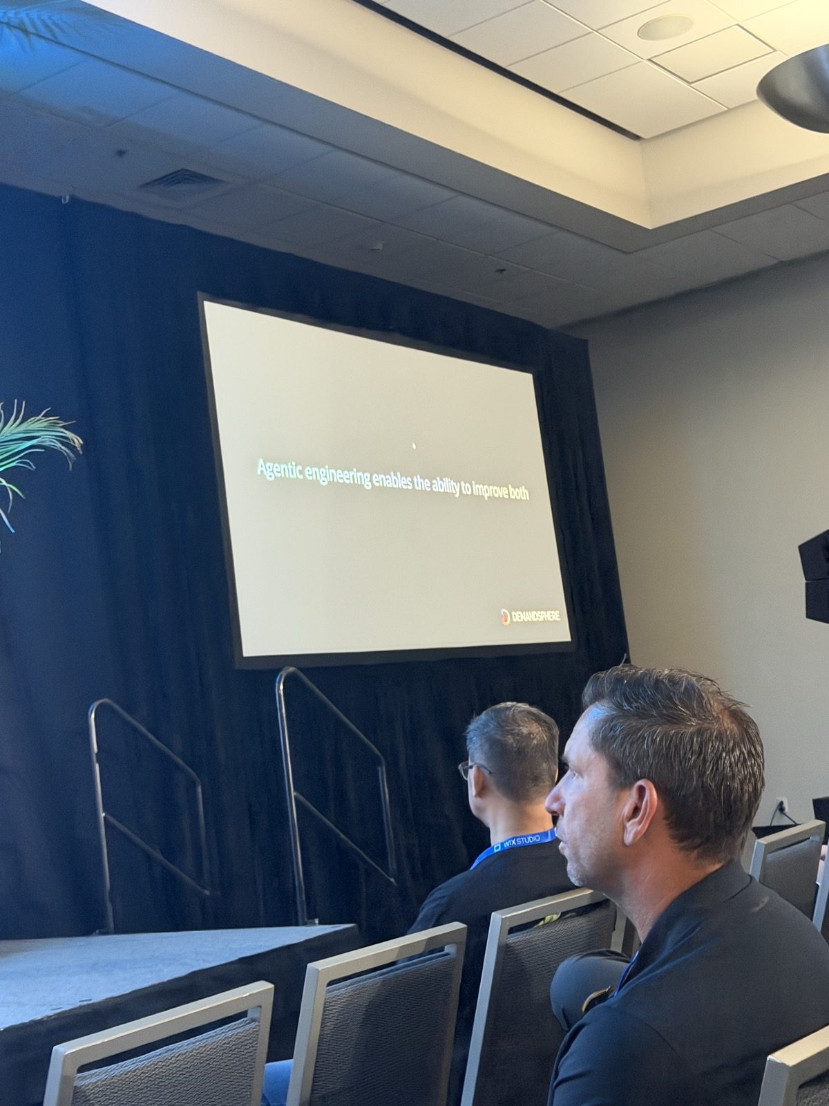 Slide con el texto 'Agentic engineering enables the ability to improve both' y el logo de DemandSphere.
